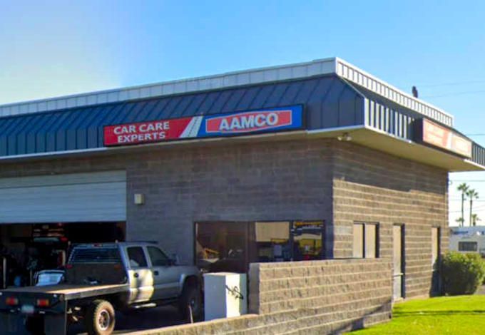 AAMCO auto repair shop with a truck in front. Blue and red sign reads 