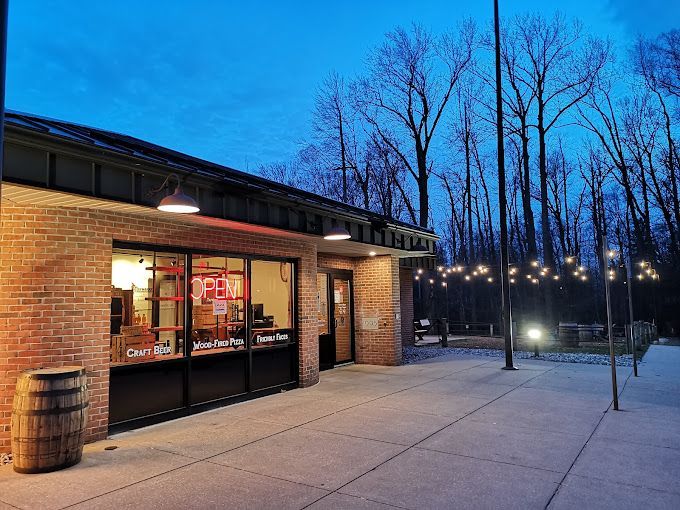 A brick building with a sign that says open on it