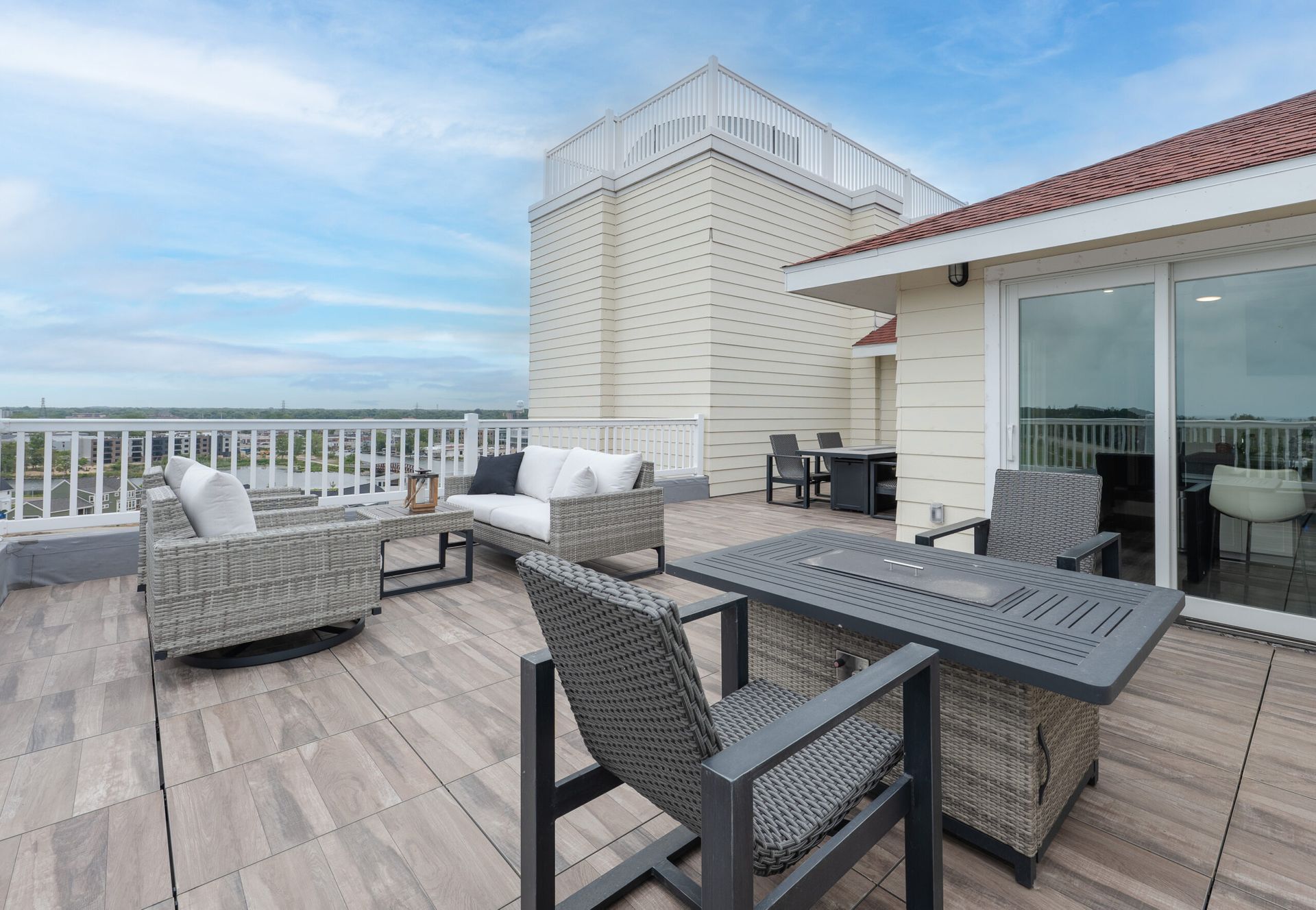There is a patio with a table and chairs on it.