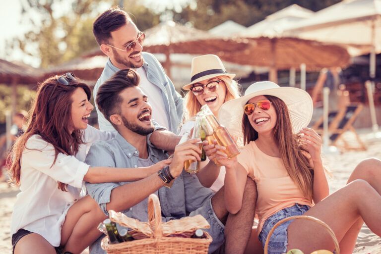 A group of young people are having a picnic on the beach.