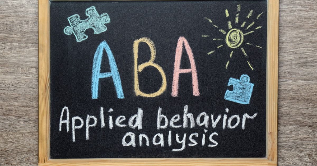 A chalkboard displays the letters