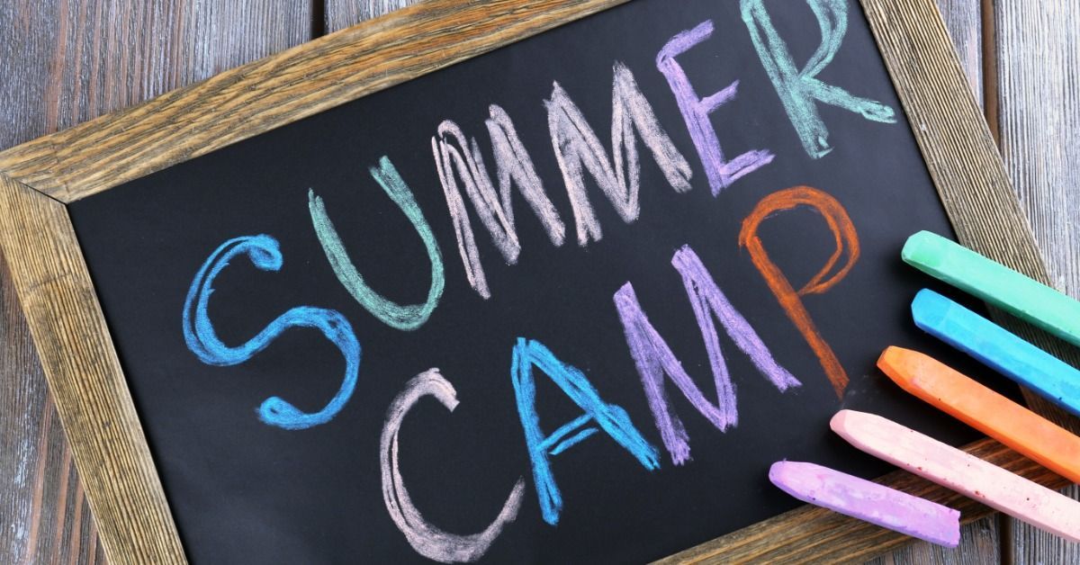 A chalkboard shows the words “SUMMER CAMP” in colorful chalk.