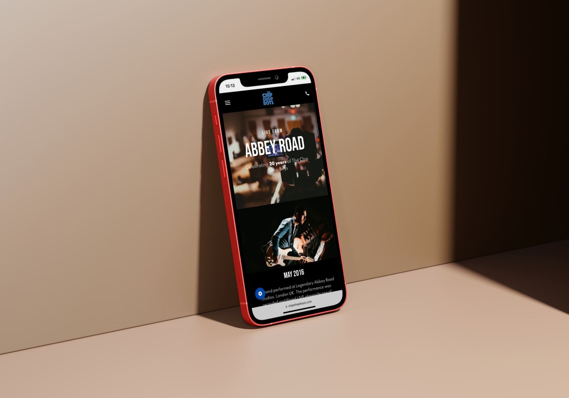 A cell phone is sitting on a table next to a wall.