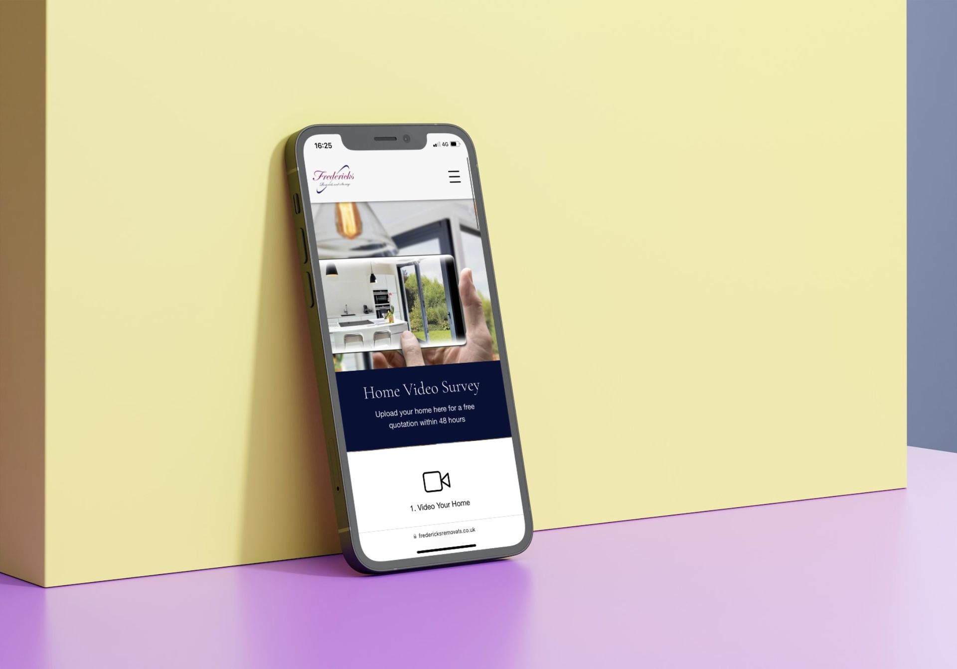 A cell phone is sitting on a purple table next to a yellow box.