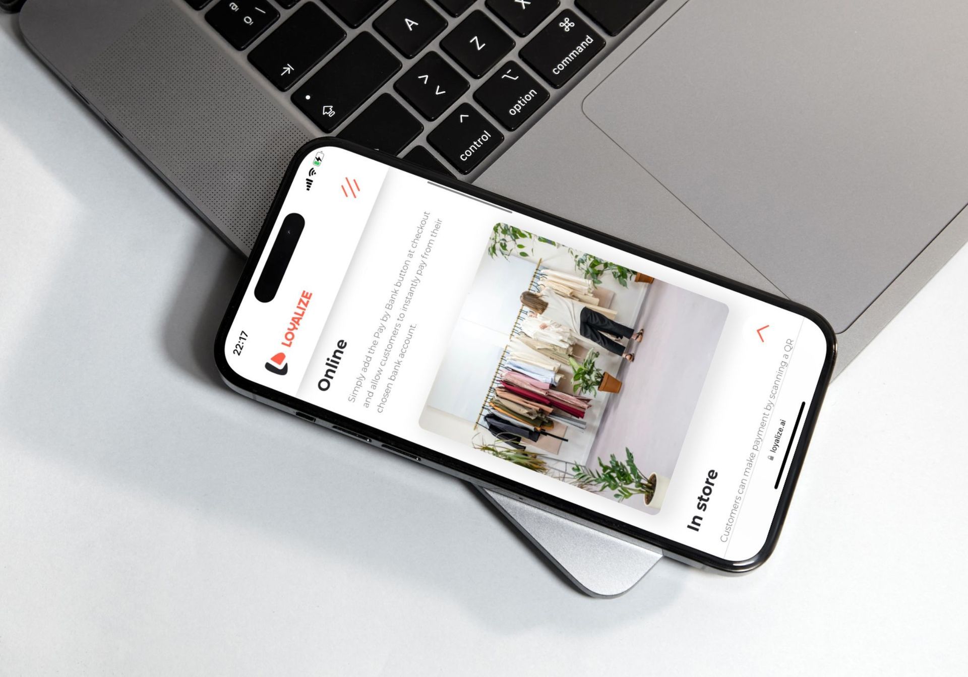A cell phone is sitting on top of a laptop keyboard