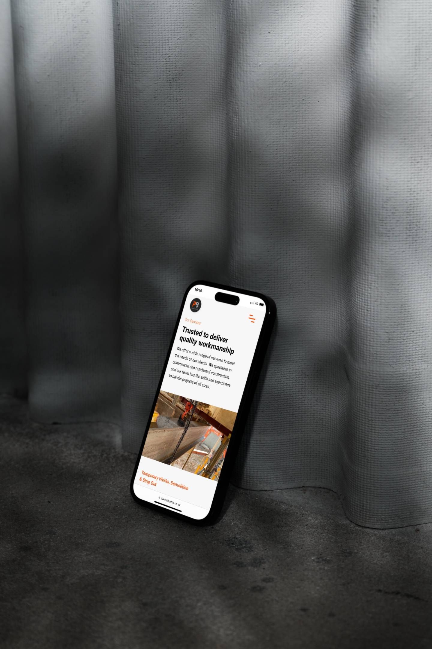 A black and white photo of a cell phone sitting on a table.