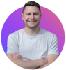 A man in a white shirt is smiling with his arms crossed