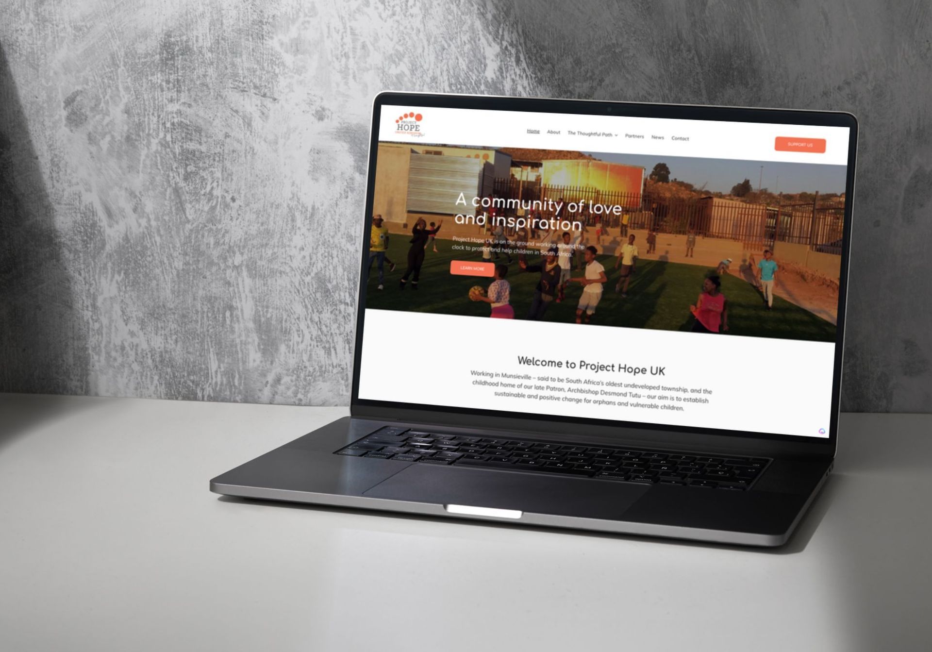 A laptop computer is open to a website on a table.