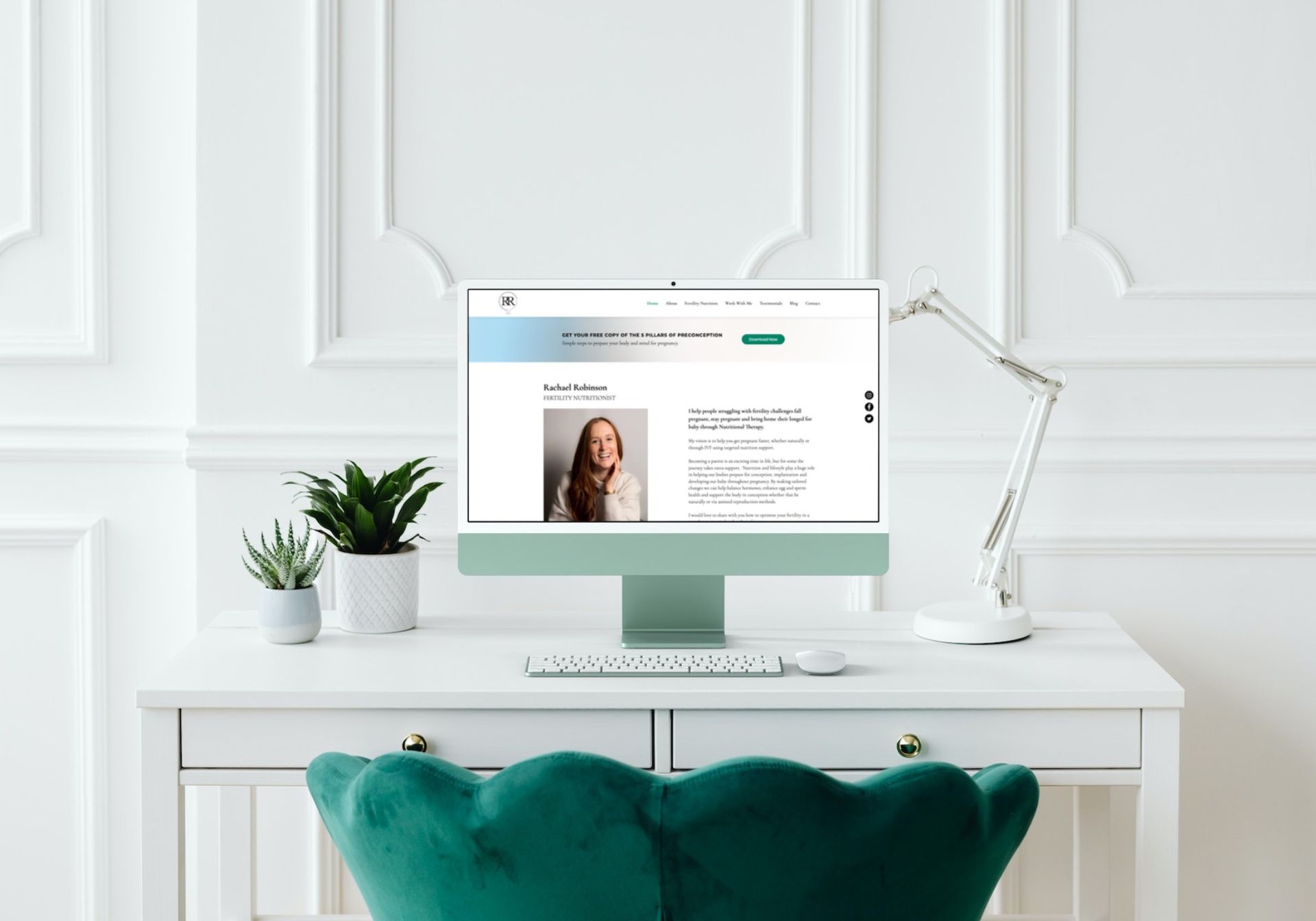 A computer is sitting on a desk next to a green chair.