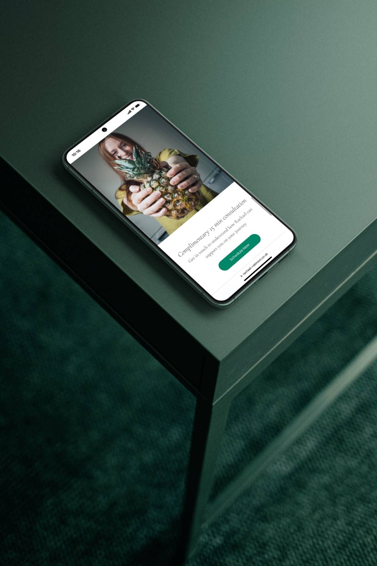 A cell phone is sitting on a green table.