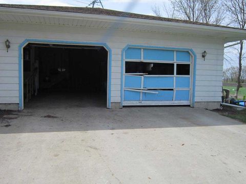 Garage Door Repair — Broken Blue Garage Door in Fargo, ND