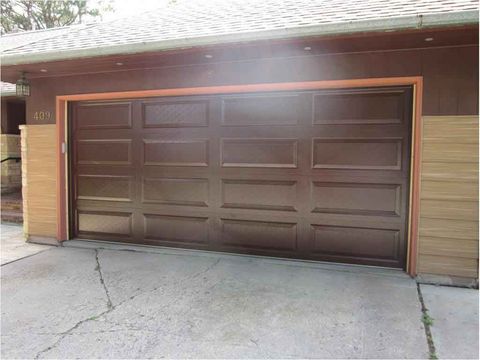 Residential Garage Door Repair — Close-Up View Of Wood Colored Glass Door in Fargo, ND
