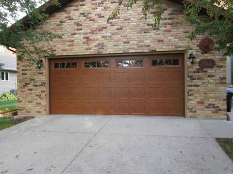 Garage Door Openers — Garage Door With Glass And Brick Wall in Fargo, ND