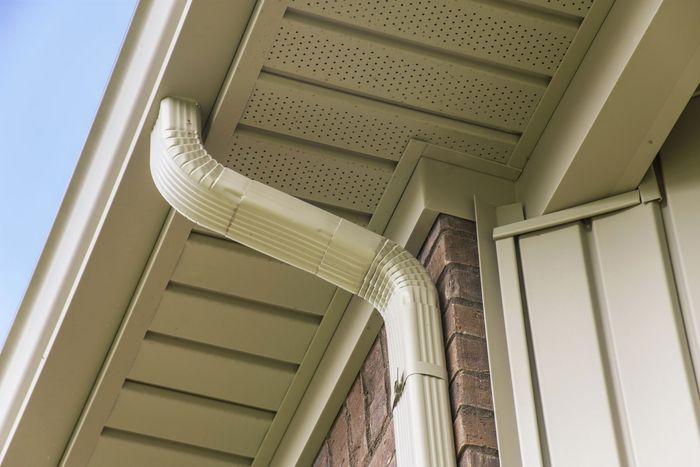 Gutter and downspout near the roof of a house