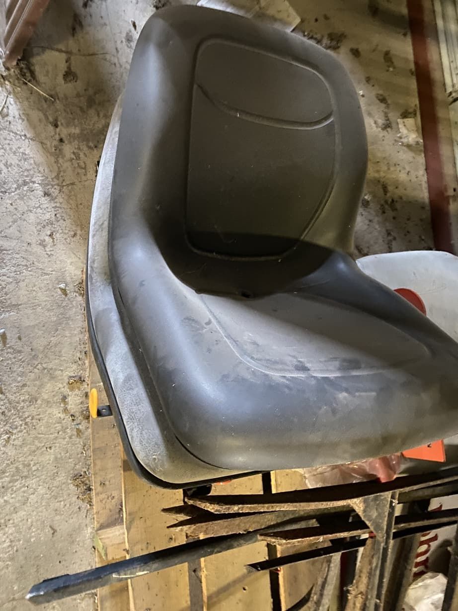 A gray chair is sitting on top of a wooden table.