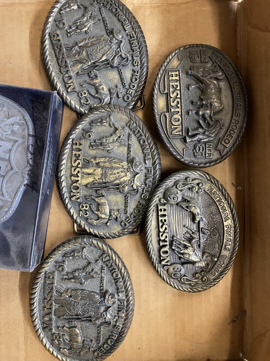 A box of belt buckles with the word hesston on them