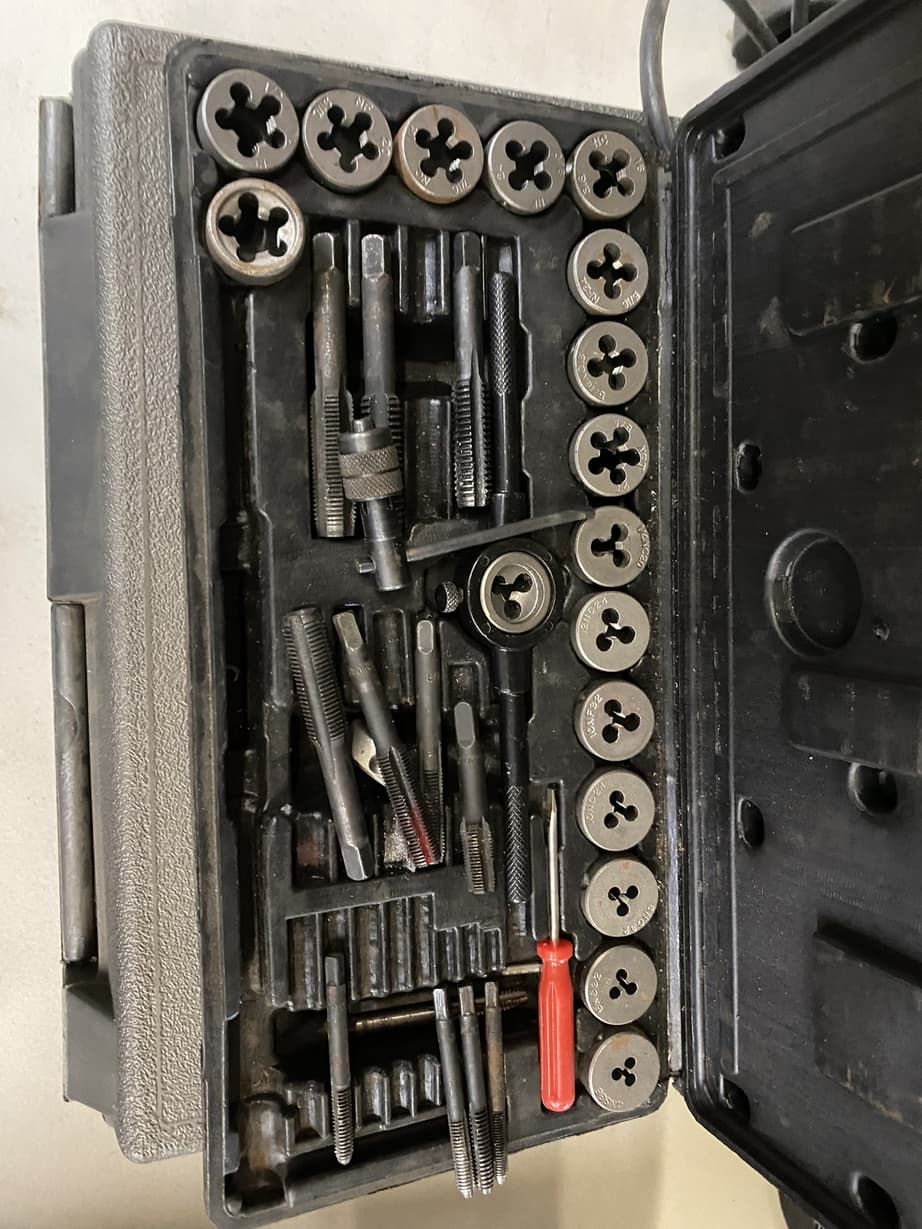 A toolbox filled with lots of tools and a red screwdriver.