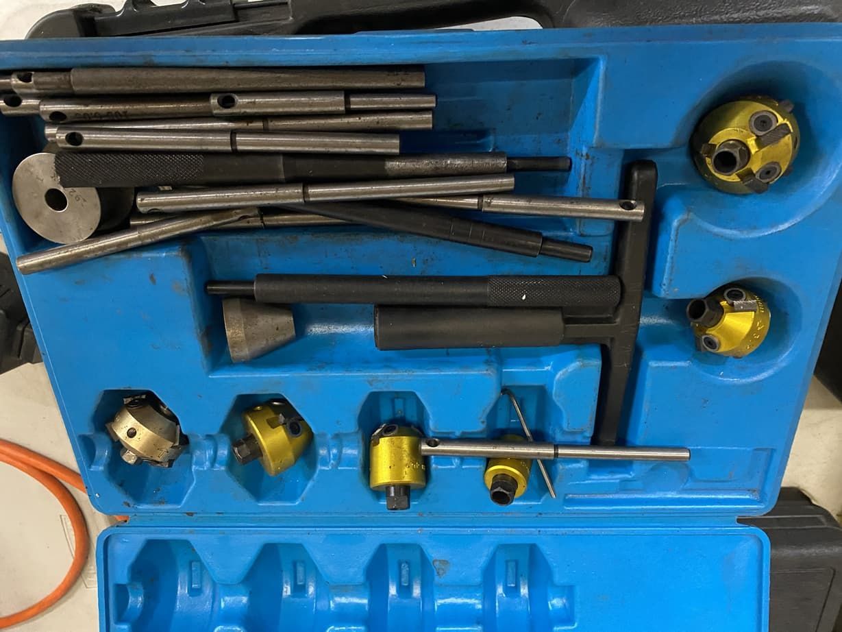 A blue box filled with tools is sitting on a table.