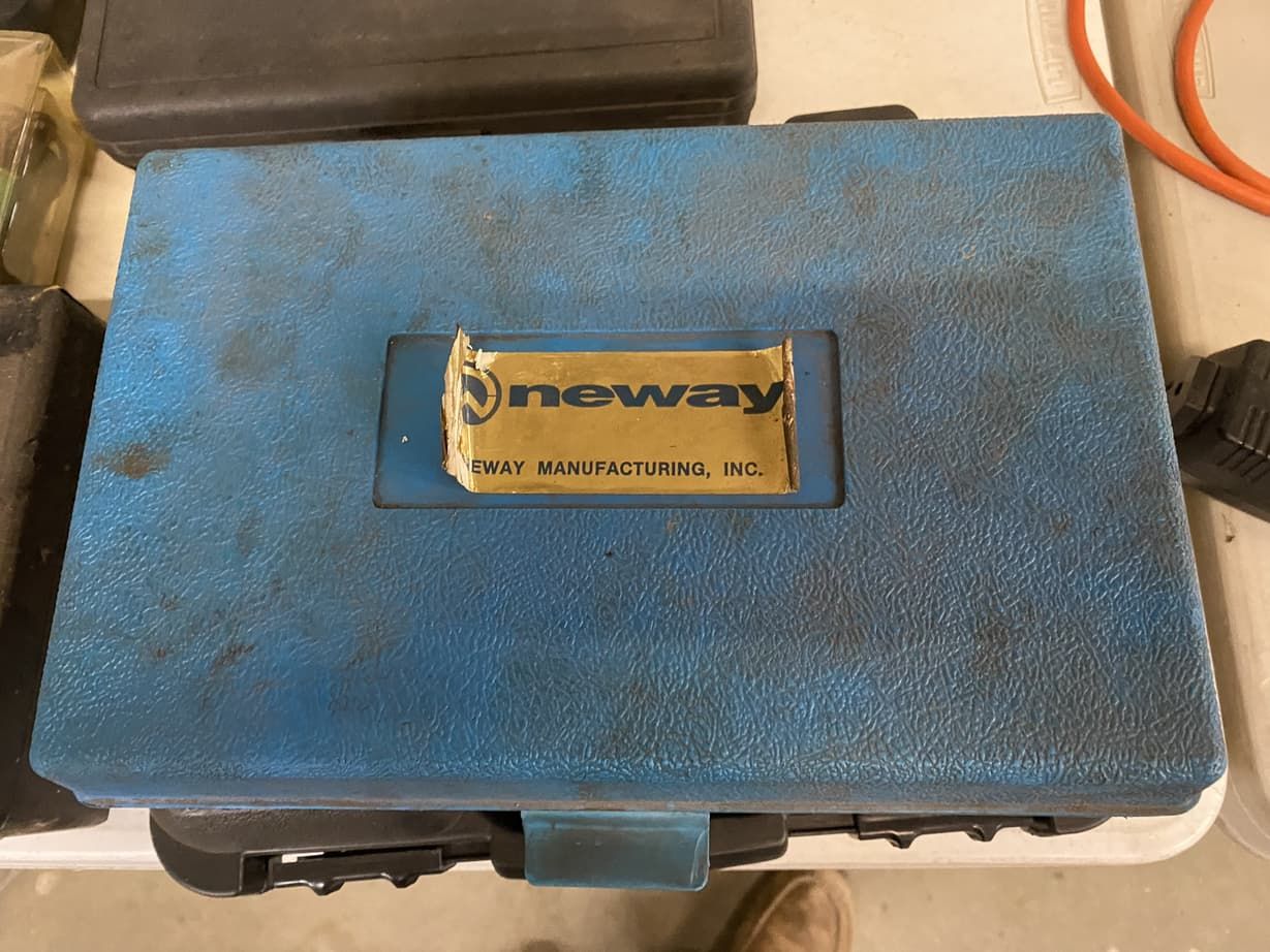 A blue newway toolbox is sitting on a white table.
