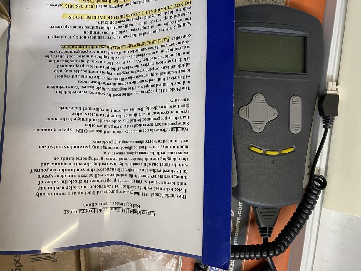 A microphone is hanging on a wall next to a piece of paper