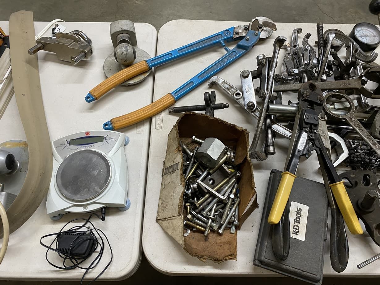 A table full of tools including a pair of pliers