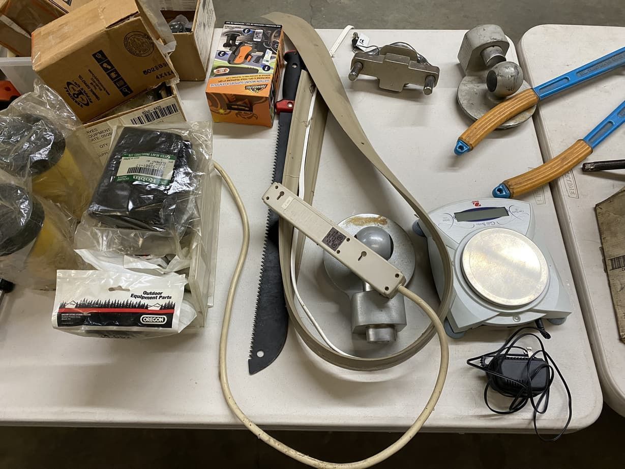 A table with a bunch of tools and boxes on it