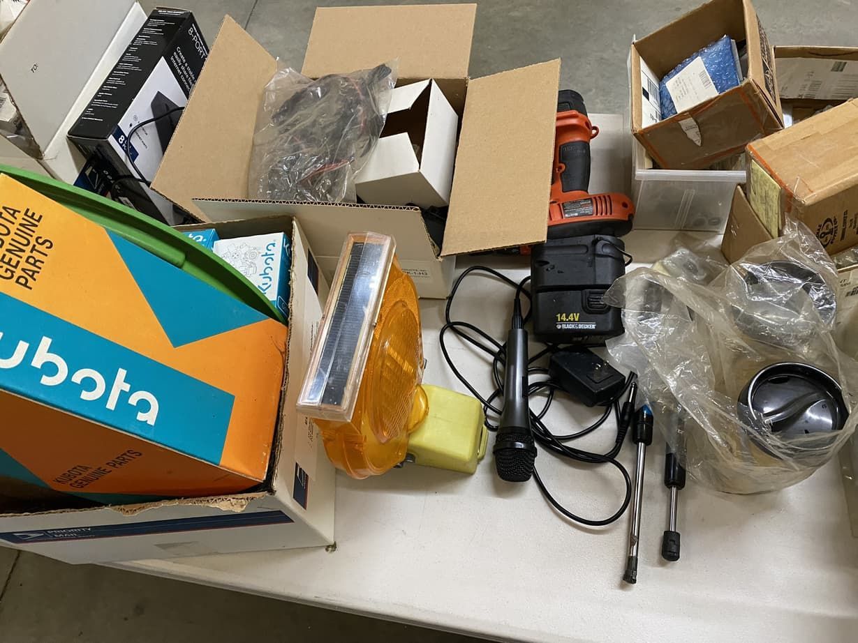 A bunch of boxes on a table with one that says ' kubota ' on it