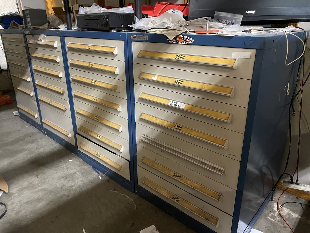 A row of drawers with yellow handles in a room.