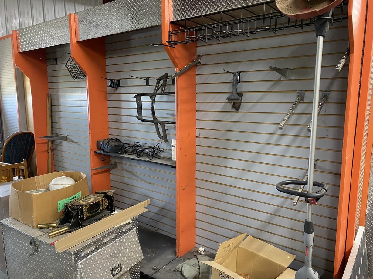 A room with a lot of tools and boxes on the floor.