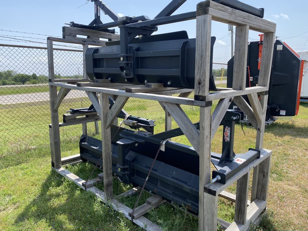 A machine is sitting in a wooden crate in a field.