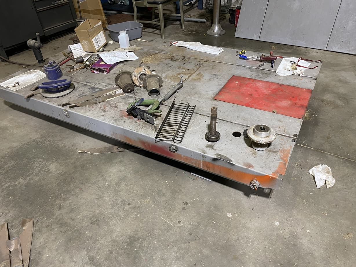 A table with a lot of tools on it in a garage.