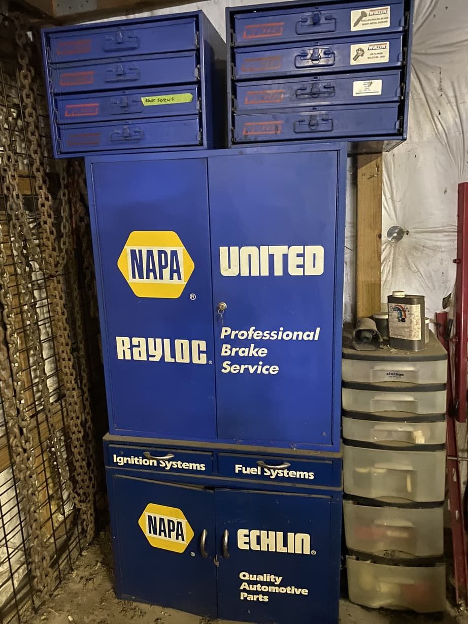 A stack of blue cabinets with napa and united written on them