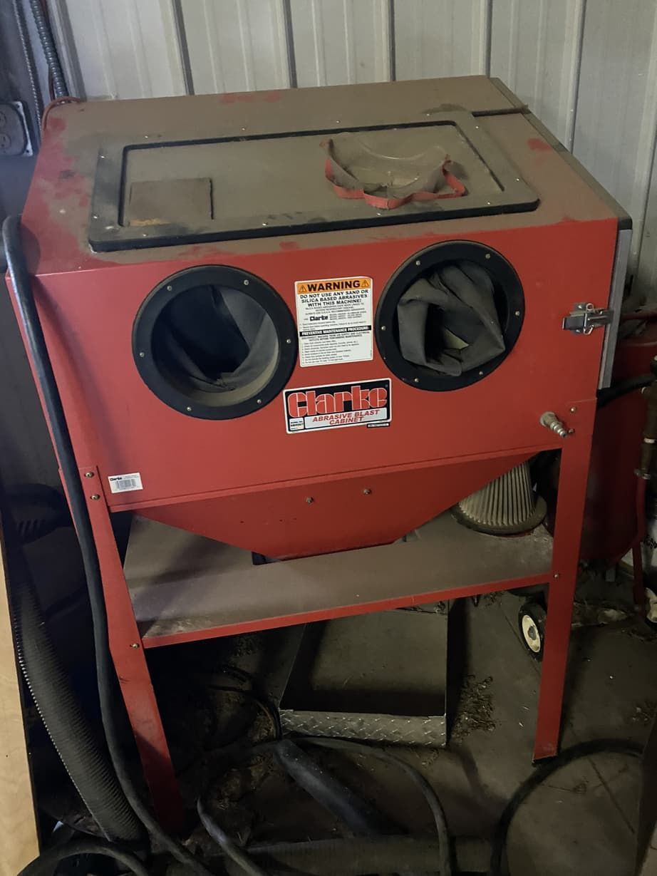 A red machine with a warning sticker on it