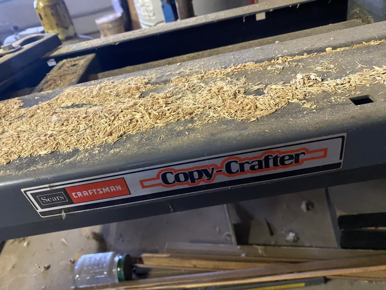 A copy crafter machine is sitting on top of a wooden table.