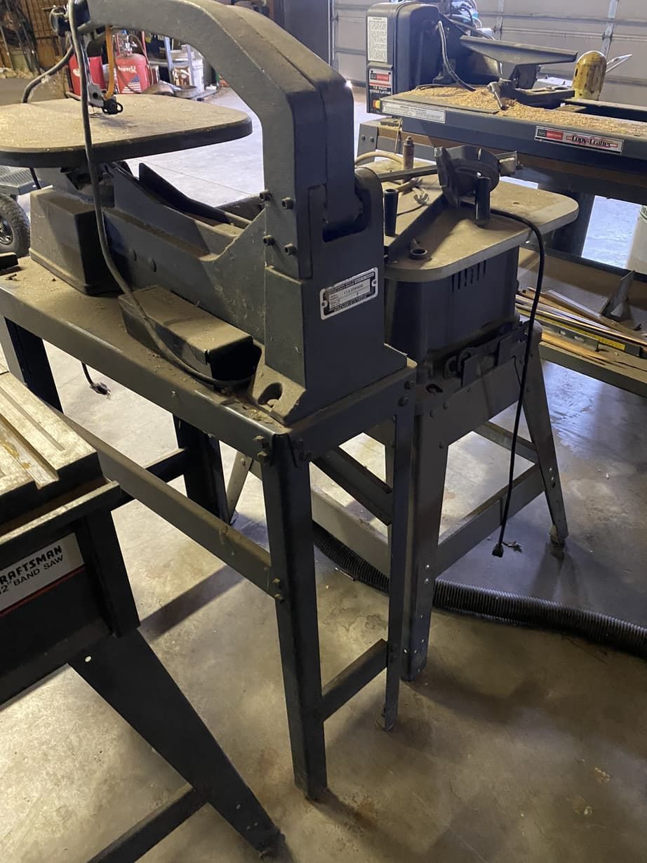 A machine is sitting on top of a wooden table in a garage.
