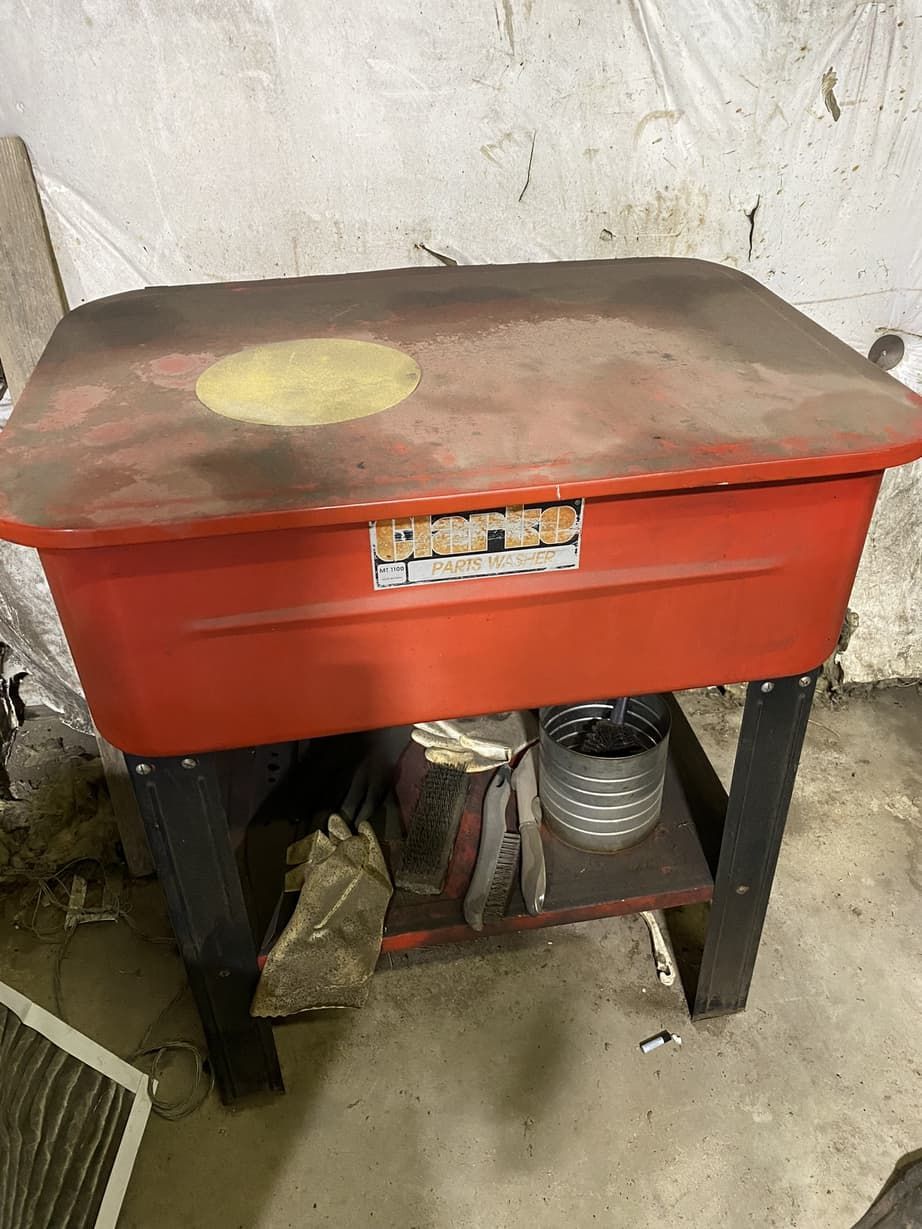 A red container is sitting on top of a black table.