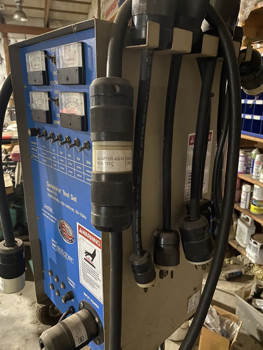 A machine with a lot of wires attached to it is sitting in a room.