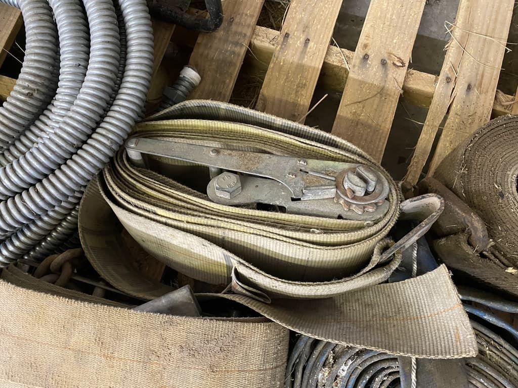 A bunch of metal objects are sitting on top of a wooden pallet.