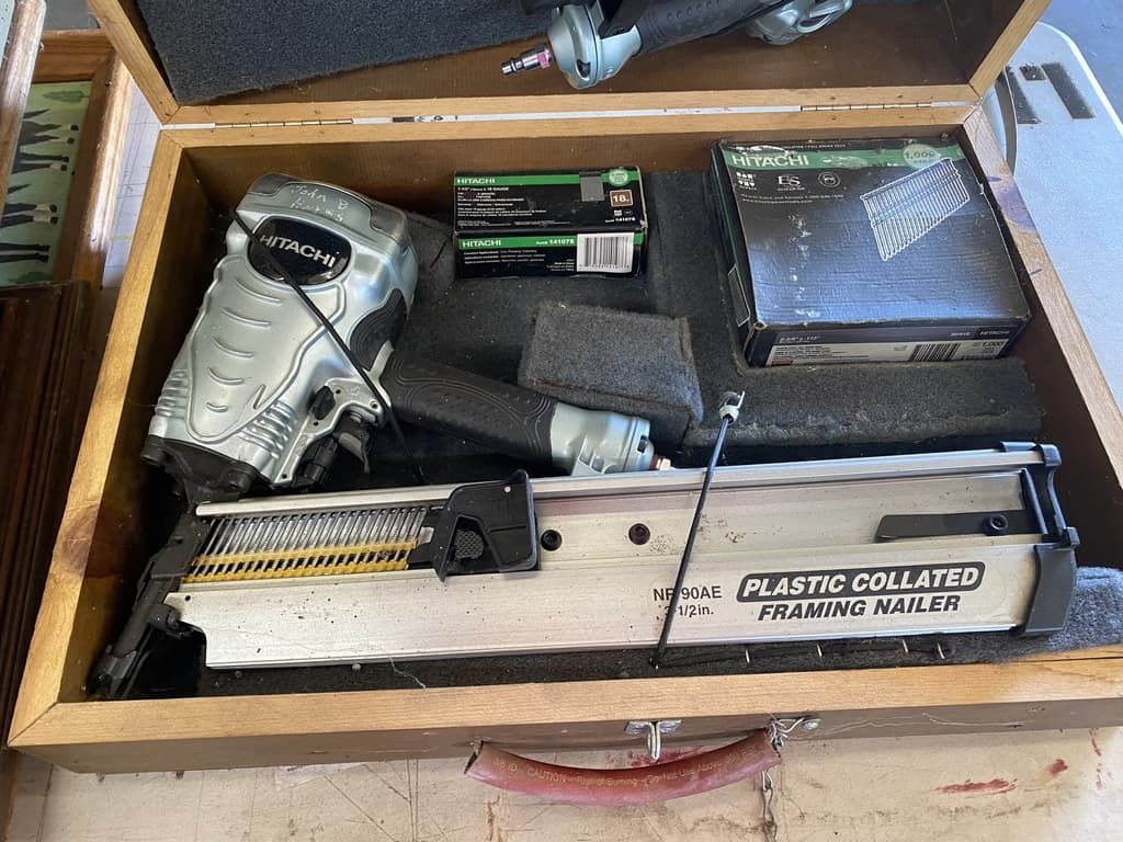 a framing nailer in a wooden case