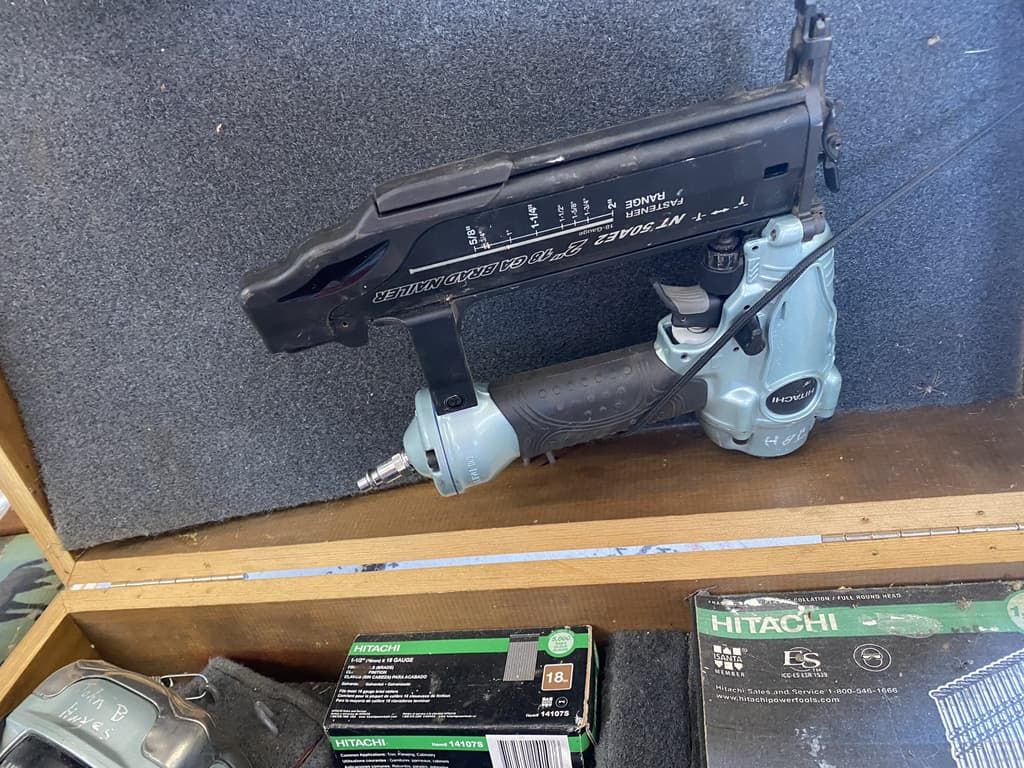 an air nailer in a wood case