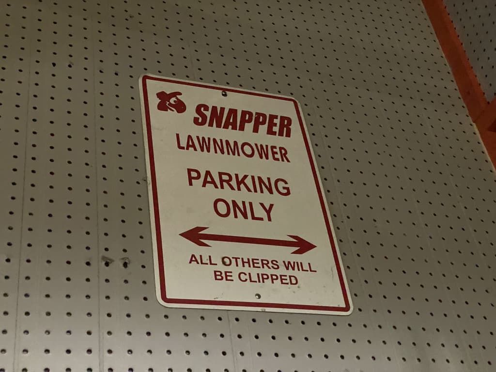 A sign that says snapper lawnmower parking only