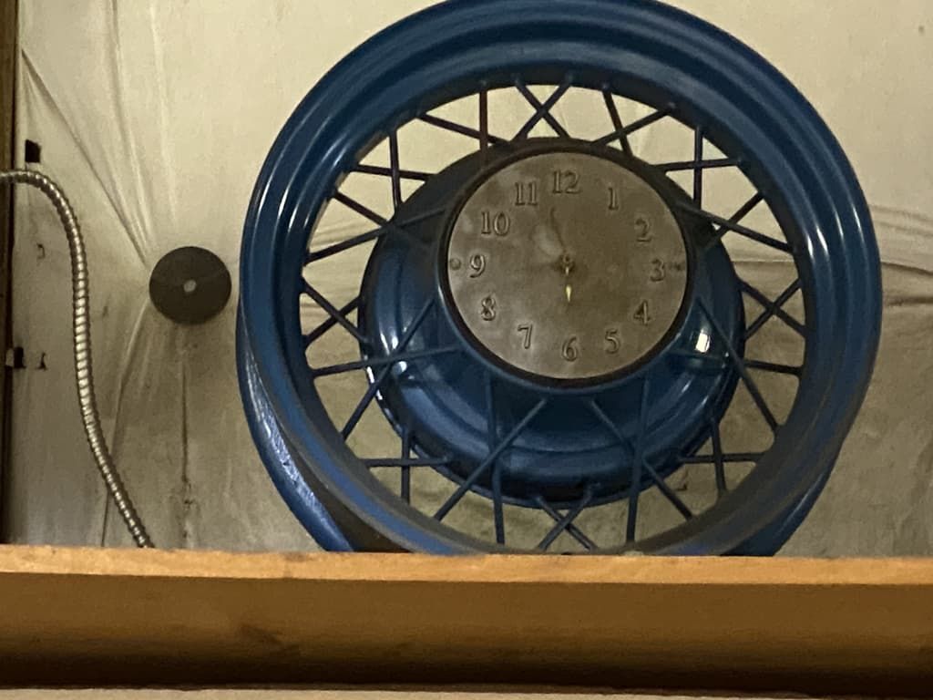 A blue wheel with a clock inside of it