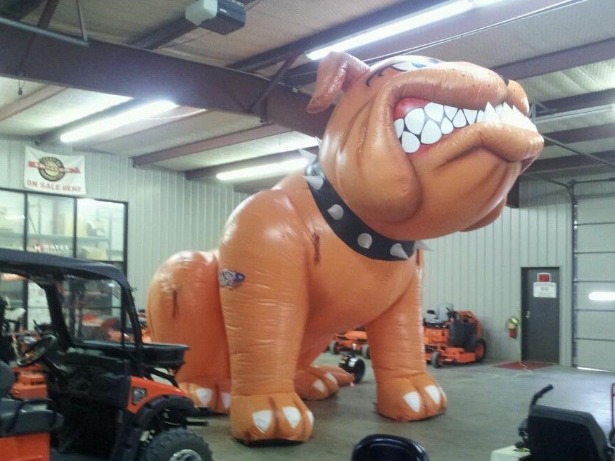 A large inflatable bulldog is sitting in a garage