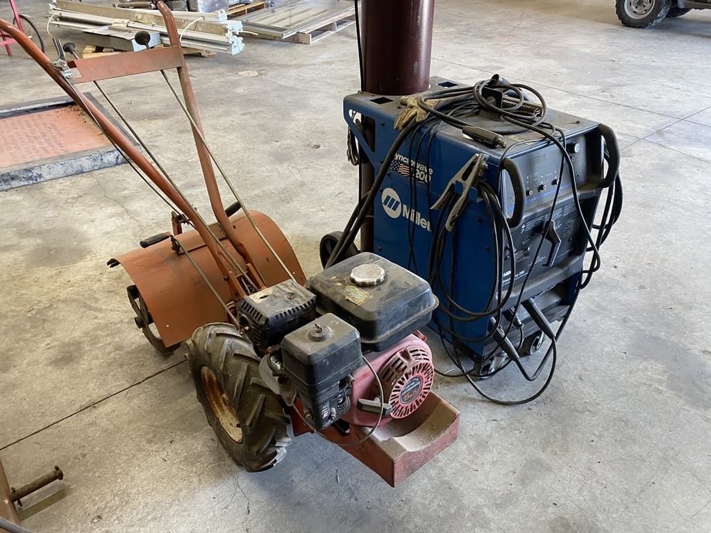 A small tractor with a welding machine attached to it.