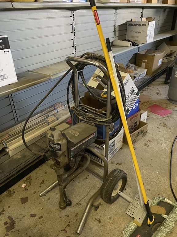 A mop is sitting on the floor next to a machine