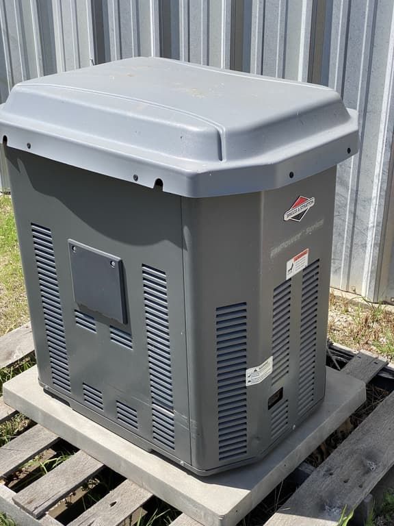 A large gray box is sitting on top of a wooden pallet.