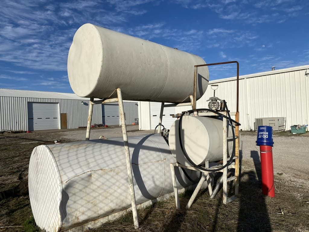 Two large white tanks are sitting in front of a building.