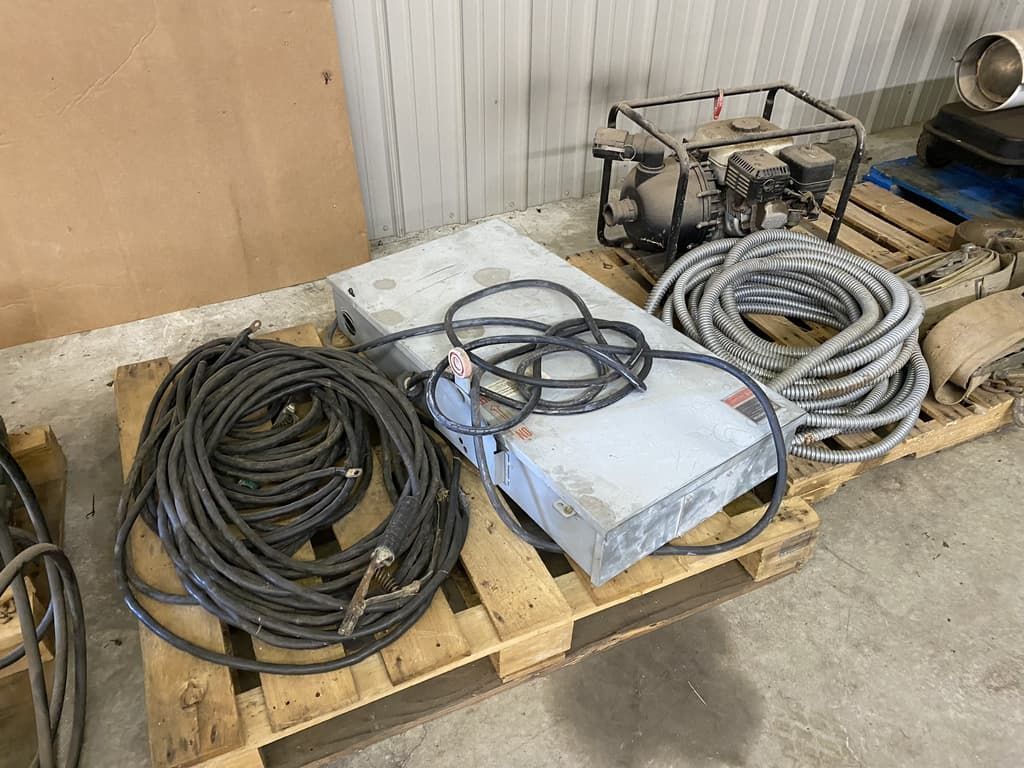 A bunch of wires are sitting on a wooden pallet.