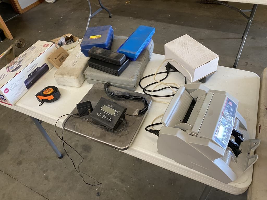 A table with a printer and other items on it