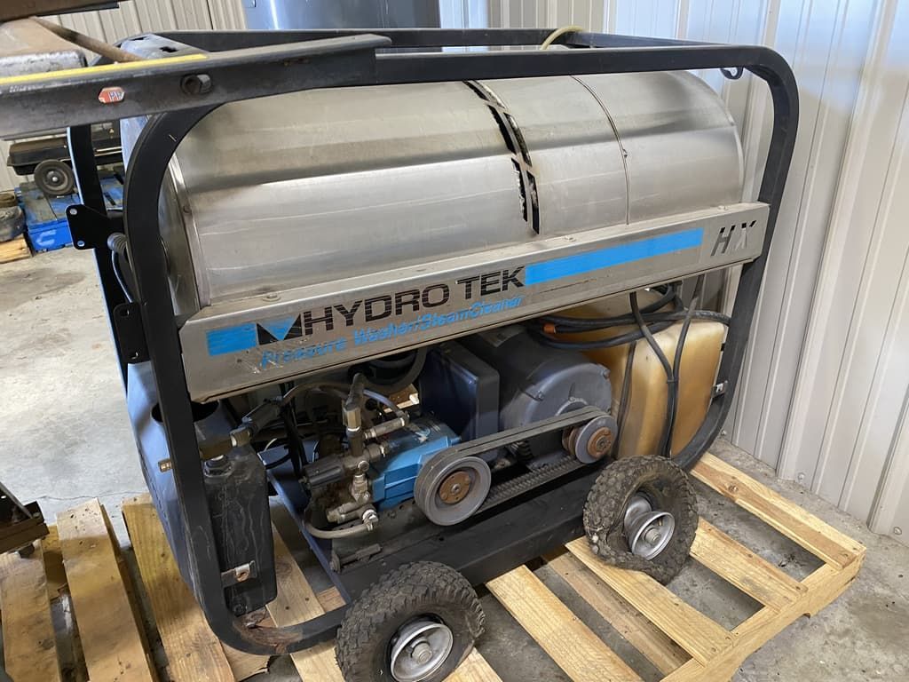 A hydro tek pressure washer is sitting on a wooden pallet.
